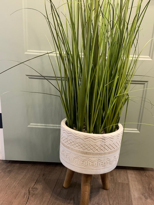 Big grass with ceramic planter with wooden legs